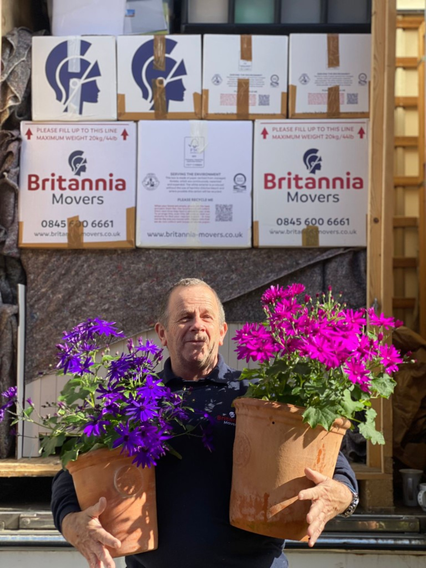 St Neots removals team member carefully handling plants during a home move